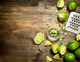 Fresh limes with grater and zest. photo