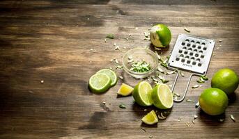 Fresh limes with grater and zest. photo