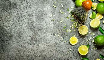 Grater with fresh limes . photo