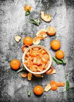 Peeled tangerines in a bowl. photo