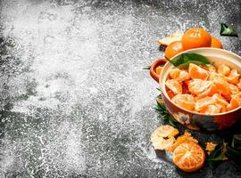 Peeled tangerines in a bowl. photo