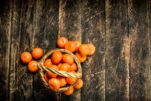 Ripe tangerines in a basket. photo