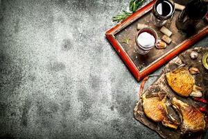 Meat grill. Fried chunks of pork grilled with spices and a bottle of red wine. photo