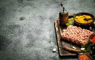 carne Relleno con especias y hierbas en un de madera tablero. foto