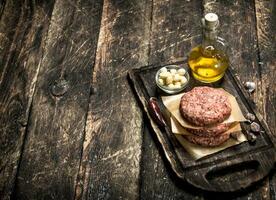 Raw burger from beef with spices and olive oil. photo