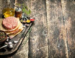 Raw burger from beef with spices and olive oil. photo