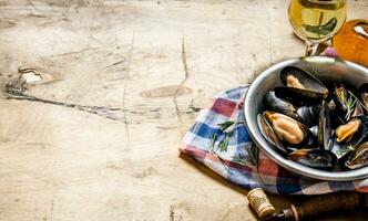 Wine with clams in a cup on the fabric. photo