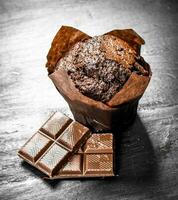 Chocolate muffins with chunks of chocolate. photo