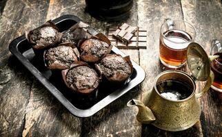 Chocolate muffins with fragrant tea. photo