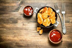 Fresh chicken nuggets with sauce and spices. photo