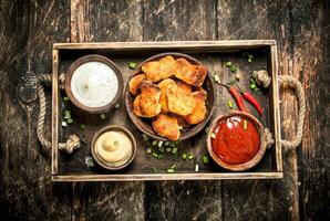 Chicken nuggets with various sauces. photo