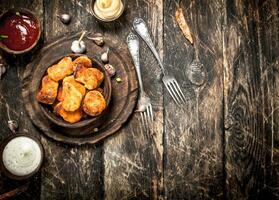 Chicken nuggets with various sauces. photo