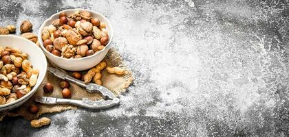 Various nuts in a bowl with a Nutcracker. photo