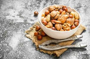 Various nuts in a bowl with a Nutcracker. photo