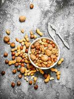 Various nuts in a bowl with a Nutcracker. photo