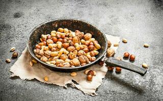 Different nuts in a frying pan. photo