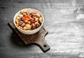 Nuts with dried fruit in a bowl. photo