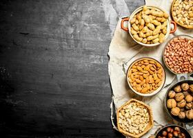 Various nuts in bowls. photo