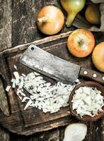 Fresh onion with old hatchet on a cutting board. photo