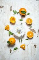 Juicer with fresh oranges. The fresh orange juice. photo