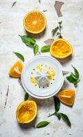 Juicer with fresh oranges. The fresh orange juice. photo