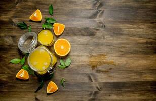 Freshly squeezed orange juice in a jar with bits of around. photo