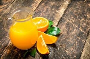 Freshly squeezed orange juice in the pitcher. photo