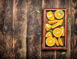 Fresh slices of oranges in the old tray. photo