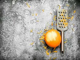 Orange zest with a grater . photo