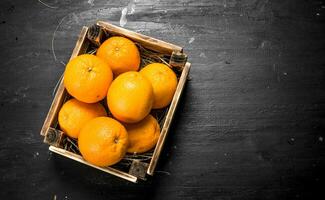 Fresh oranges in an old box. photo