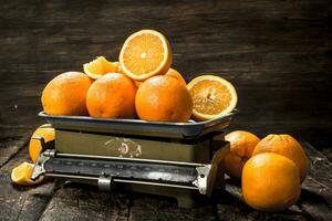 Ripe oranges on the scales. photo