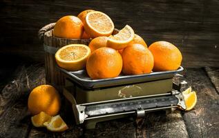 Ripe oranges on the scales. photo