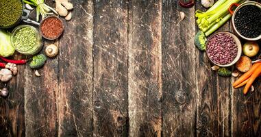 Organic Food. Vegetables and various bean seeds. On the old wooden table. photo