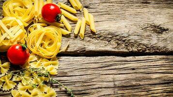 Dry pasta with cherry tomatoes and herb. photo