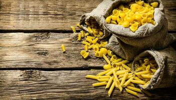 Several types of pasta in old bags. photo