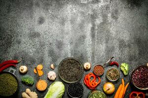 Organic Food. A variety of legumes with vegetables. On rustic background. photo