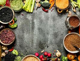 Organic Food. Frame of fresh vegetables and legumes. On rustic background. photo