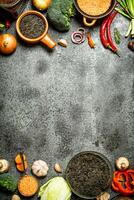 Organic Food. A variety of legumes with vegetables. On rustic background. photo
