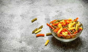 Colorful pasta in bowl. photo