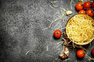 Pasta background. Noodles with tomatoes and garlic. photo