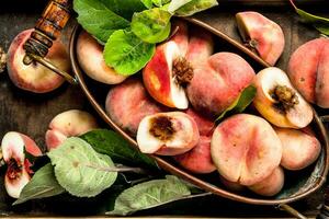 Ripe peaches on a tray. photo