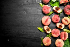 Ripe peaches with leaves. photo