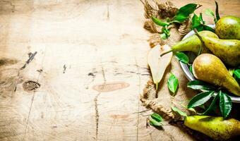 Pears with leaves in bowl on old fabric. photo