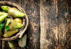 Fresh pears in a wooden bucket. photo