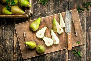 Slicing ripe pears on a cutting board. photo