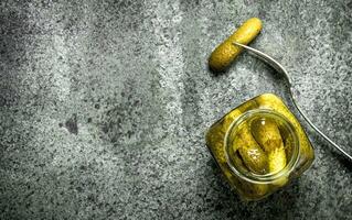 Pickled cucumbers in jar. photo