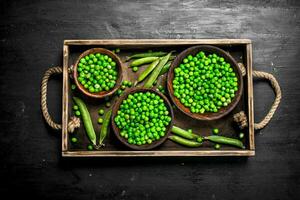 Fresh green peas in a bowl. On black chalkboard. photo