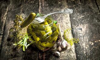 Pickled cucumbers with herbs and spices. photo