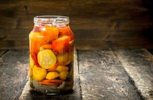 Marinated tomatoes in glass jar. photo