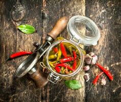 Marinated hot chili peppers with seamer. photo